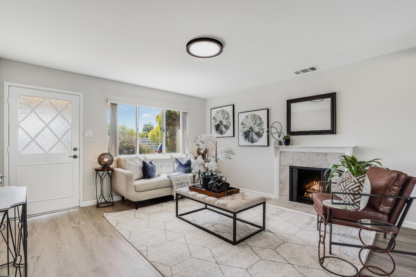 508 Mountain View Avenue Belmont, CA 94002 - Photo 3 of 38 a living room with furniture a fireplace and a table