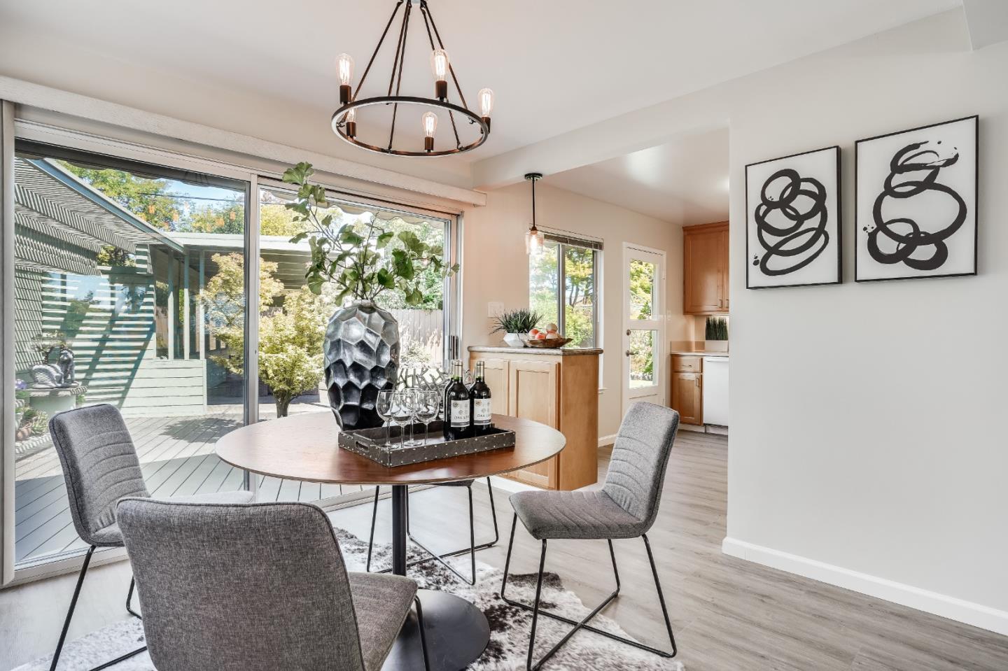 508 Mountain View Avenue Belmont, CA 94002 - Photo 5 of 38 a dining room with furniture a chandelier and wooden floor