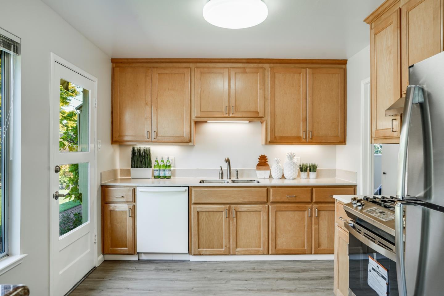 508 Mountain View Avenue Belmont, CA 94002 - Photo 8 of 38 a kitchen with stainless steel appliances granite countertop a stove a sink dishwasher and a refrigerator with wooden cabinets
