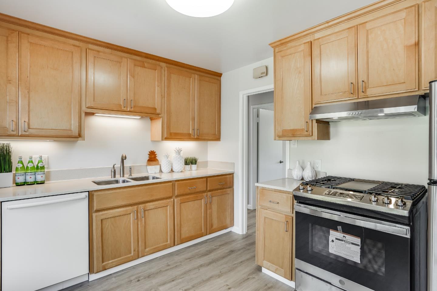 508 Mountain View Avenue Belmont, CA 94002 - Photo 9 of 38 a kitchen with stainless steel appliances granite countertop a stove a sink dishwasher and a refrigerator with wooden cabinets