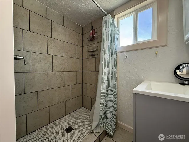 a kitchen with stainless steel appliances a stove a sink a refrigerator and cabinets