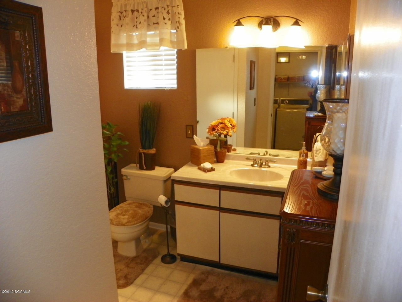 1103 Erie Court Rio Rico, AZ 85648 - Photo 14 of 16 a bathroom with a sink toilet and mirror