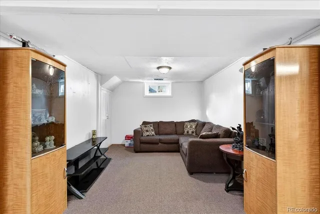 a living room with furniture and a mirror