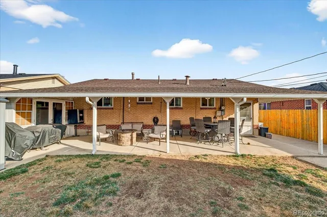 a view of a patio with a table and chairs
