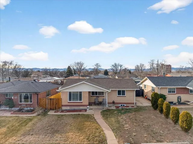 a view of a big house with a big yard and large trees