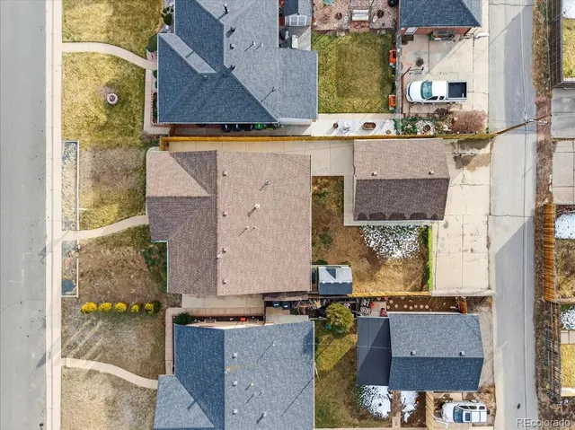 an aerial view of a residential houses with outdoor space