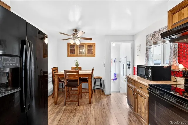 a view of a dining room with furniture and a kitchen