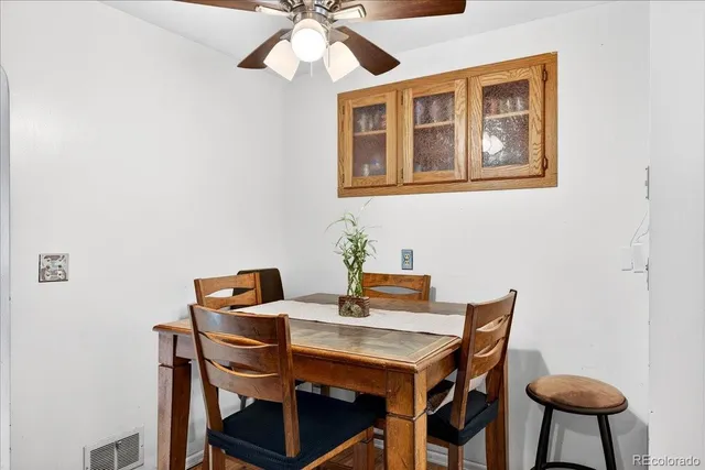 a view of a dining room with furniture and wooden floor