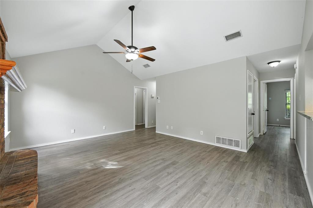 602 Valleyridge Court Decatur, TX 76234 - Photo 12 of 27 a view of an empty room with a window and wooden floor