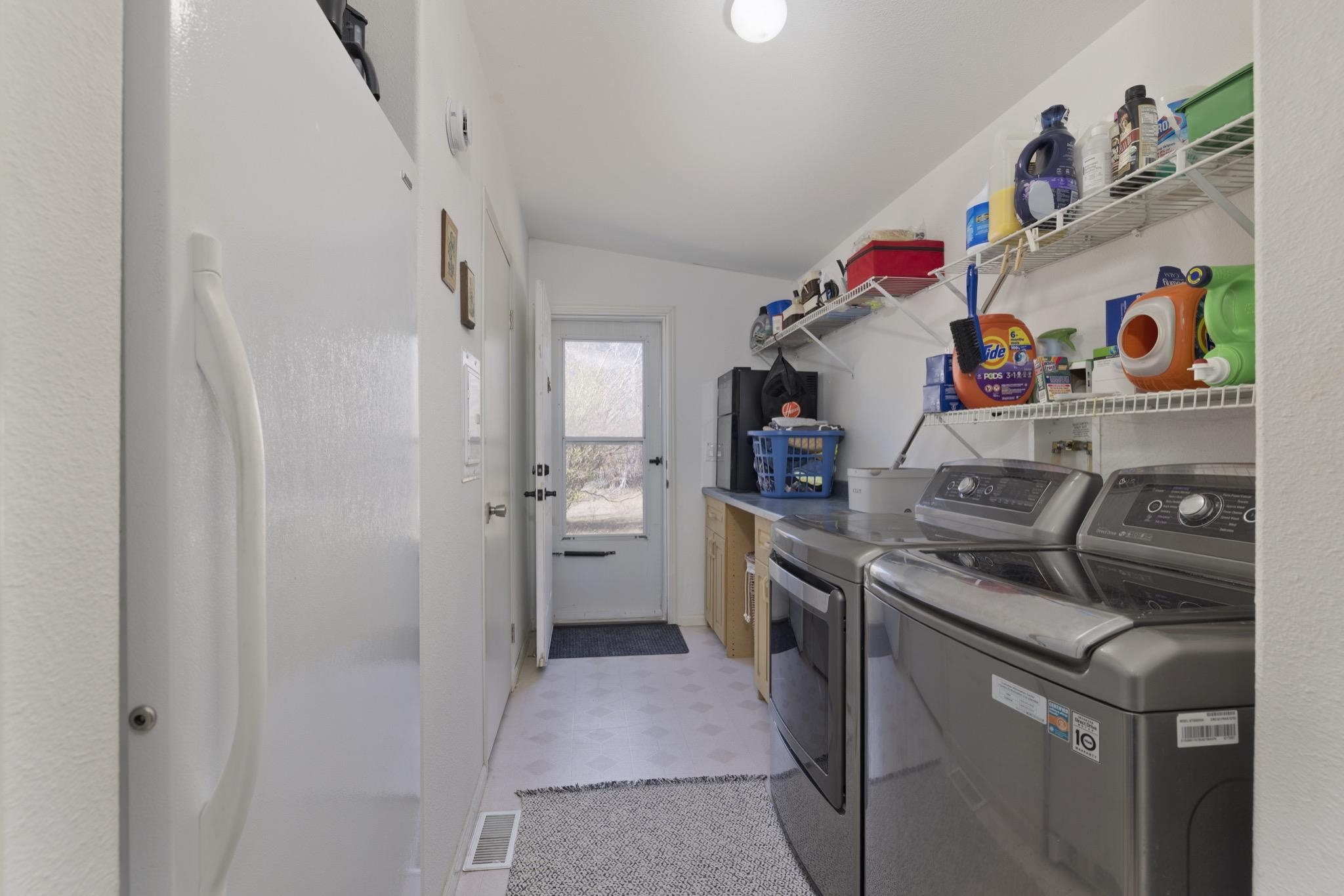 790 Cemetery Road Lee Vining, CA 93541 - Photo 16 of 39 Laundry area with white wire shelving, countertop space, and light-toned flooring