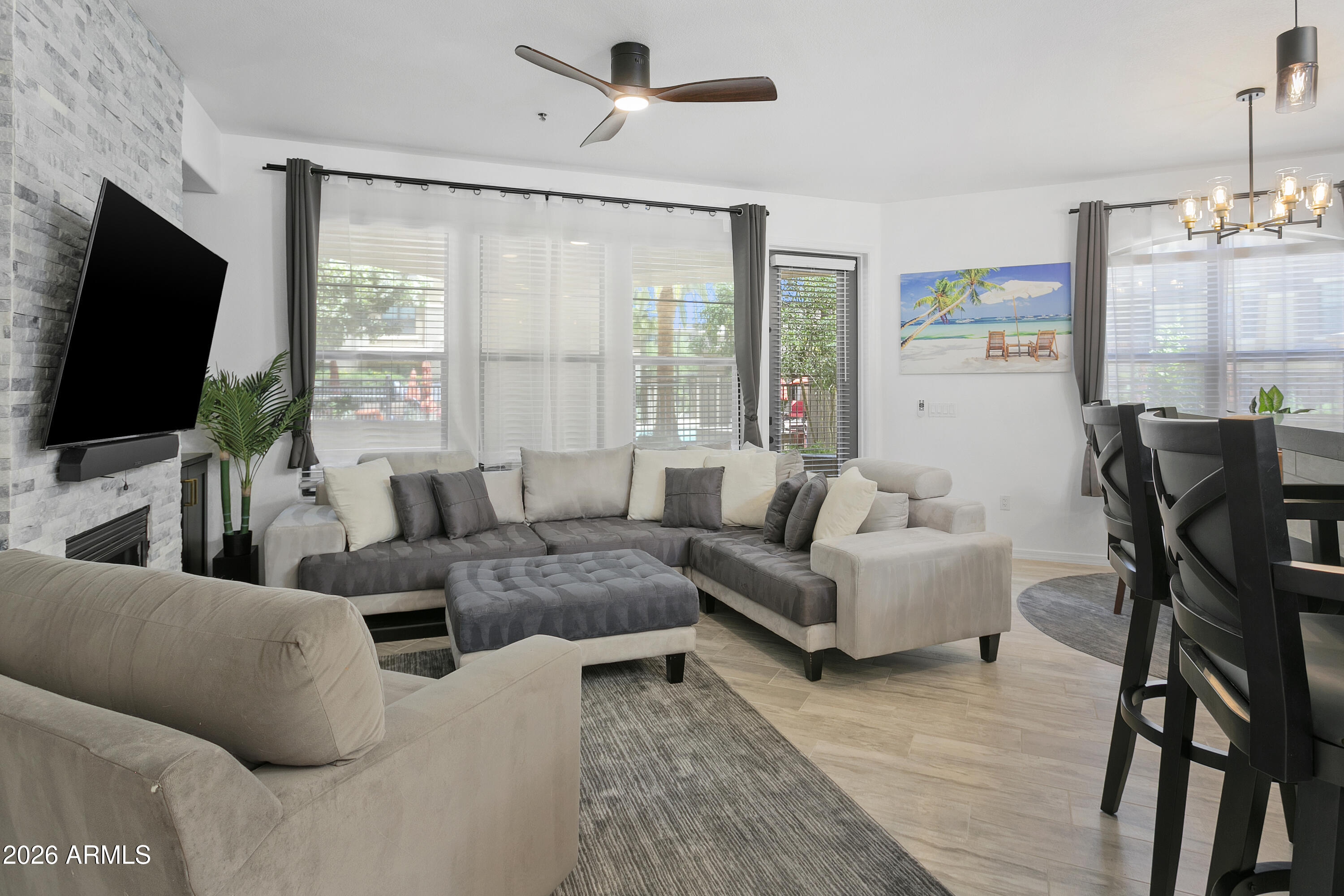 7601 East Indian Bend Road, Unit 1017 Scottsdale, AZ 85250 - Photo 12 of 49 a living room with furniture and a flat screen tv