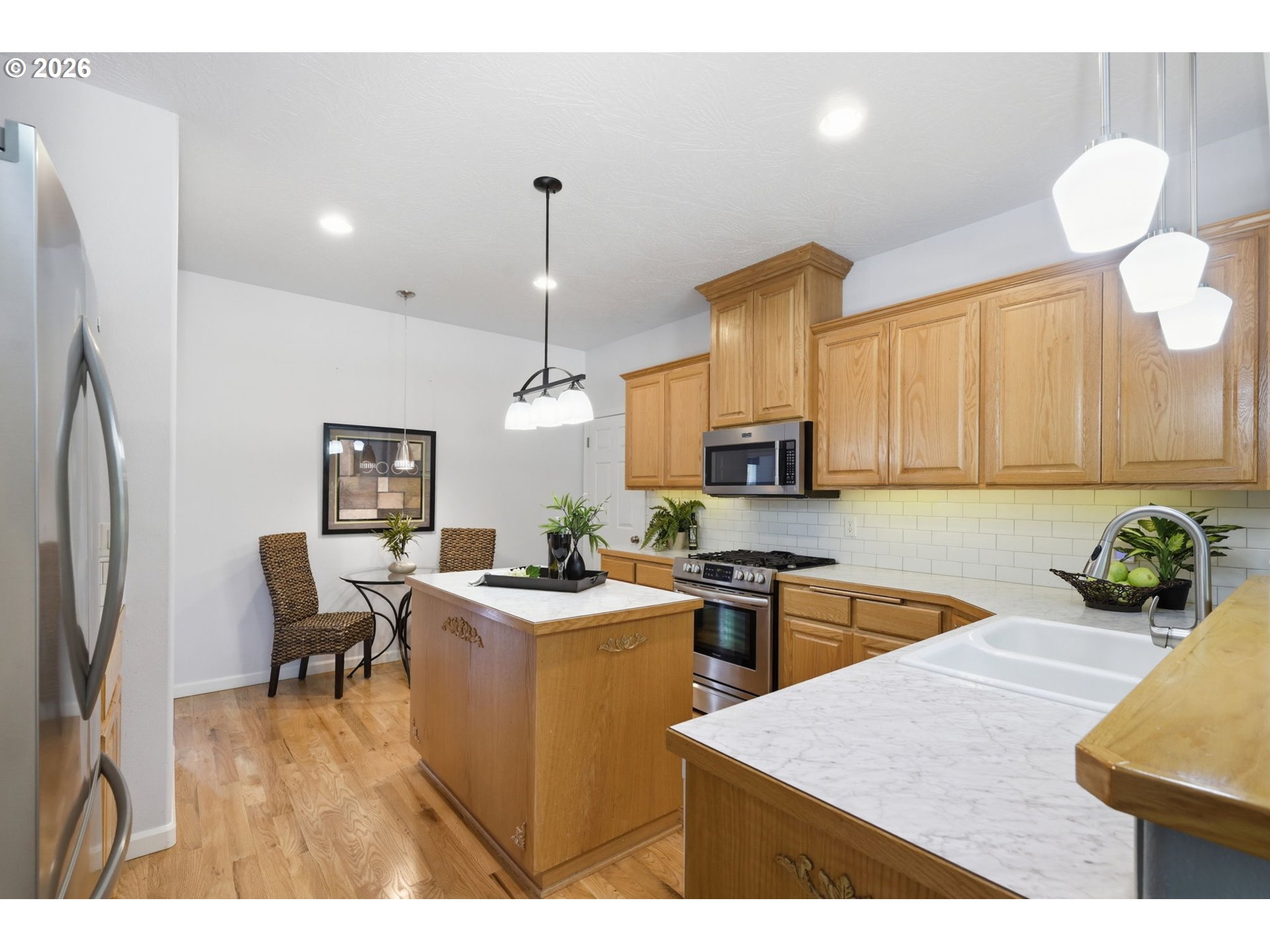 667 72nd Street Springfield, OR 97478 - Photo 16 of 40 a kitchen with stainless steel appliances kitchen island granite countertop a sink a stove and refrigerator