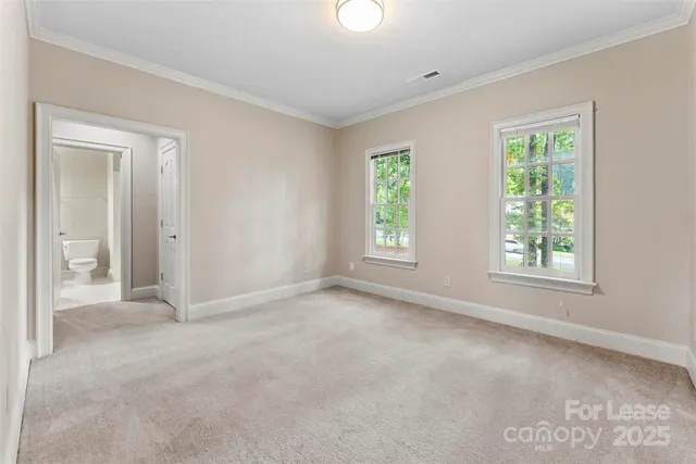 an empty room with windows and closet