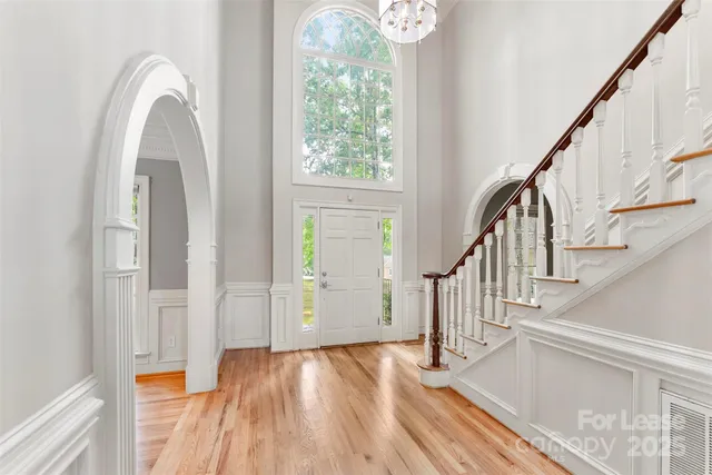 a view of entryway with wooden floor and stairs