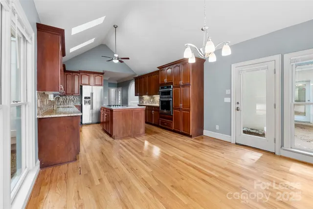 a view of a kitchen with cabinets and stainless steel appliances