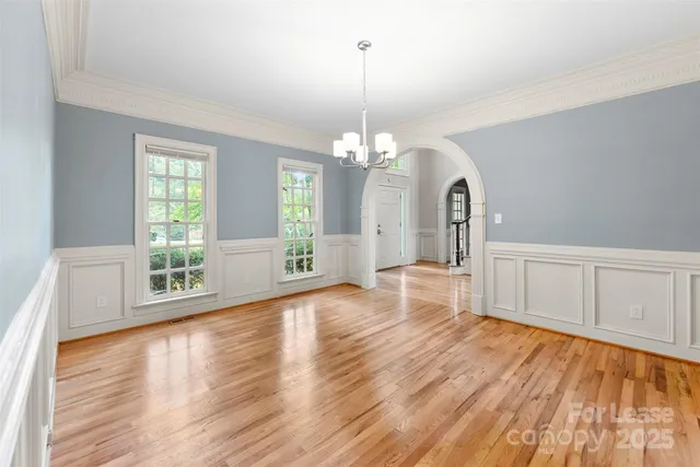 a view of a living room with hardwood floor and windows