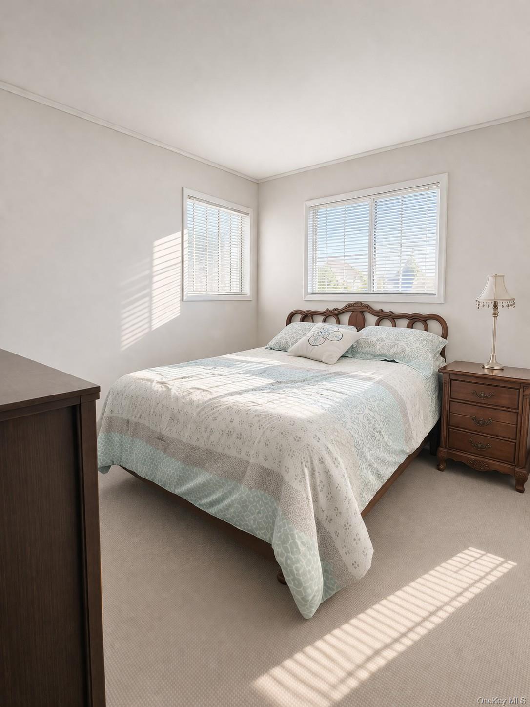 39 Barracuda Road East Quogue, NY 11942 - Photo 11 of 15 a bedroom with a bed and a window