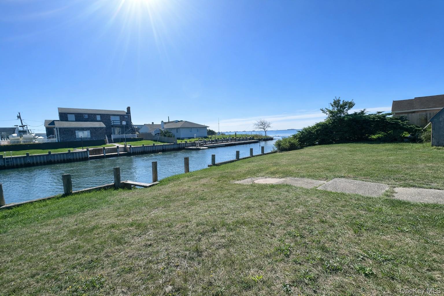 39 Barracuda Road East Quogue, NY 11942 - Photo 3 of 15 a swimming pool with lawn chairs and a table