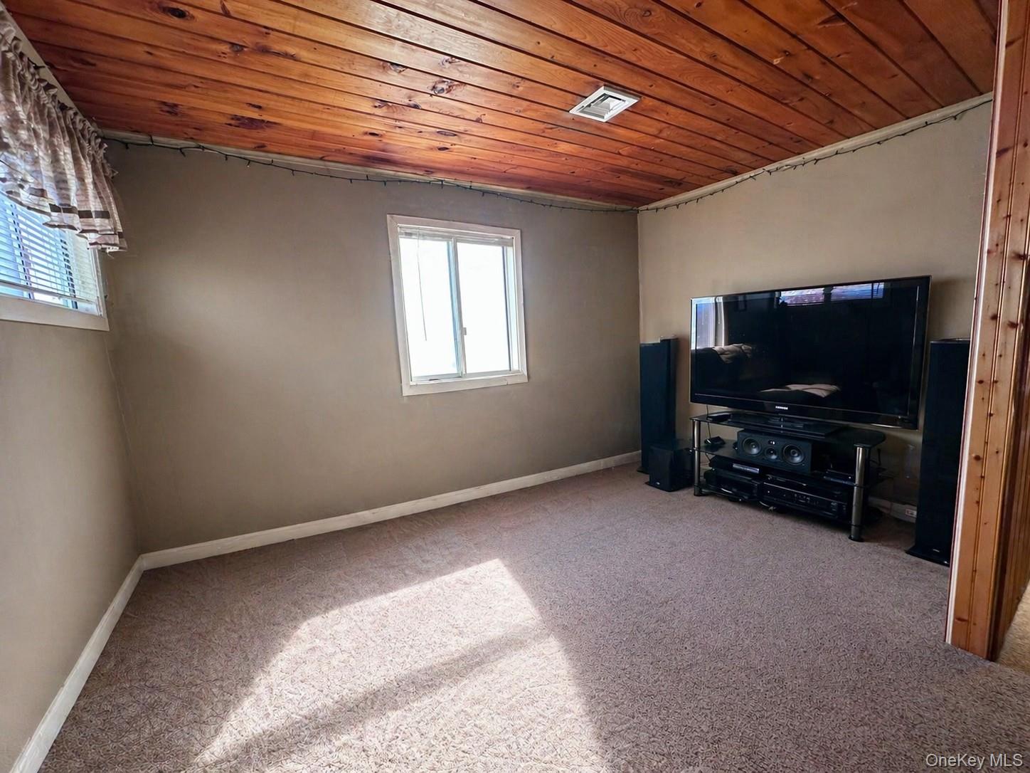 39 Barracuda Road East Quogue, NY 11942 - Photo 7 of 15 a view of livingroom with furniture and a flat screen tv