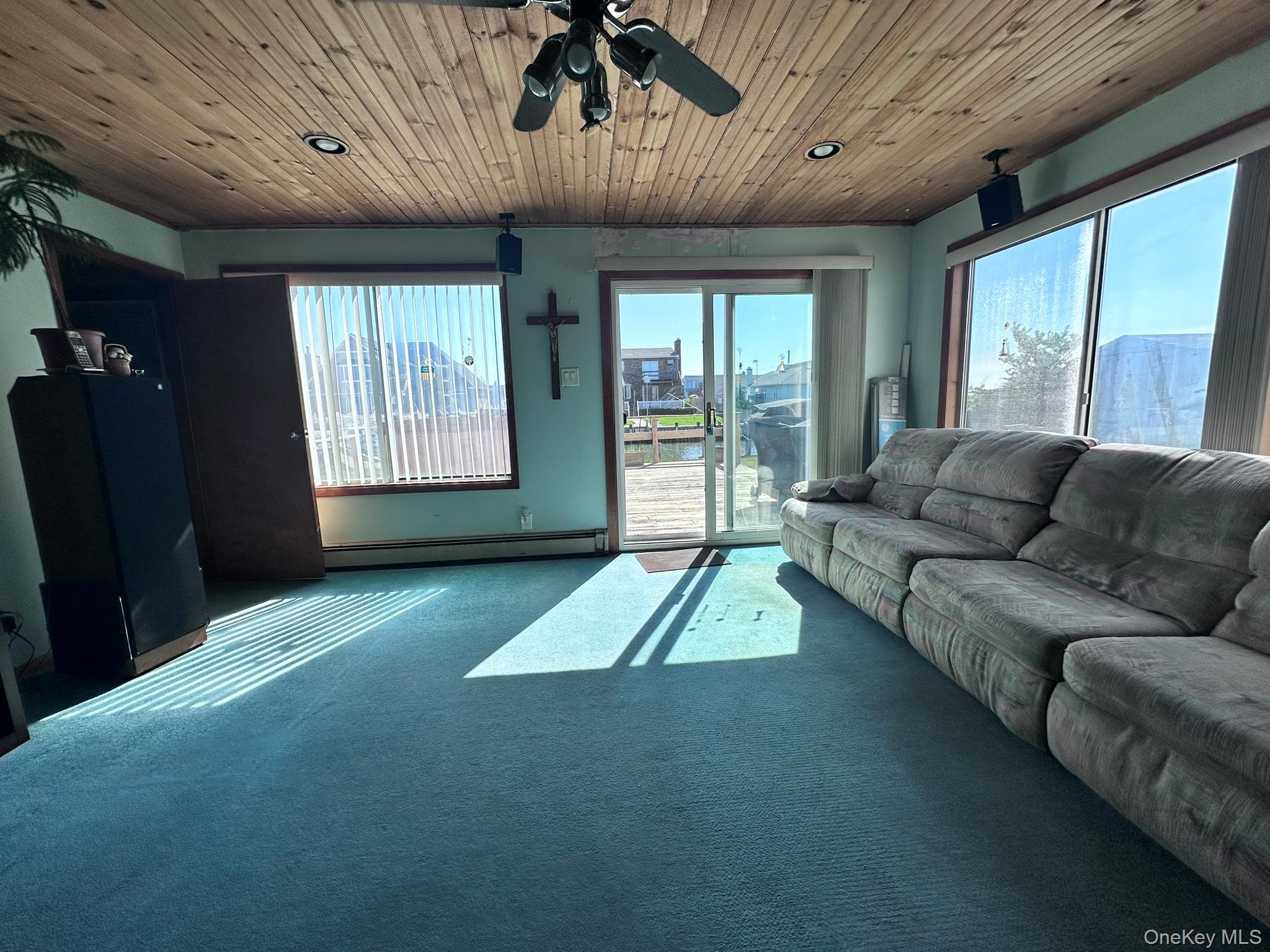 39 Barracuda Road East Quogue, NY 11942 - Photo 10 of 15 a living room with furniture and a open kitchen