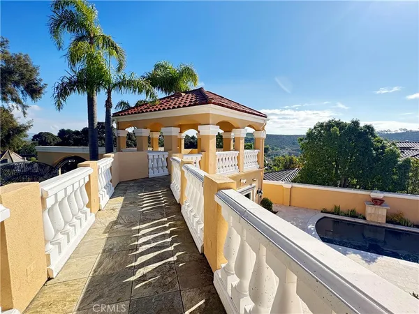 a view of a chairs and table in the balcony