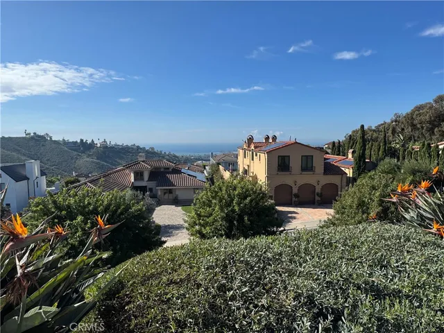 a view of a roof deck with table and chairs with wooden floor and fence