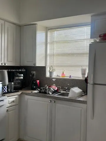 a kitchen with a refrigerator and a stove