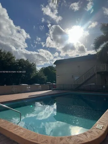 a view of a swimming pool with a yard in the background