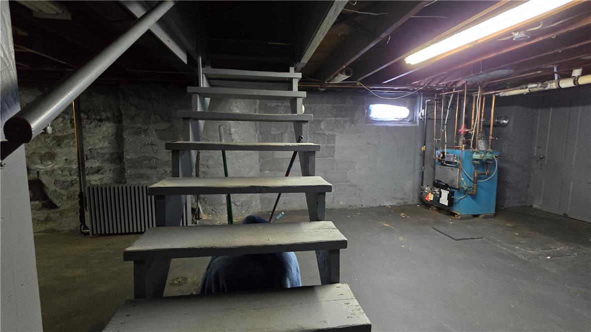 883 North Locust Street Hazleton, PA 18201 - Photo 83 of 83 Functional basement space, perfect for storage or future customization, with a visible water heater and stairs for easy access.