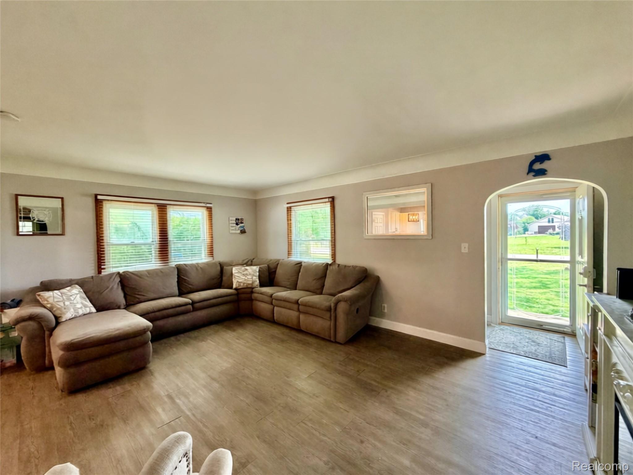 3840 East Dunbar Road Monroe, MI 48161 - Photo 14 of 38 Spacious interior featuring wood-finish flooring, light-toned walls, and multiple windows with wood blinds