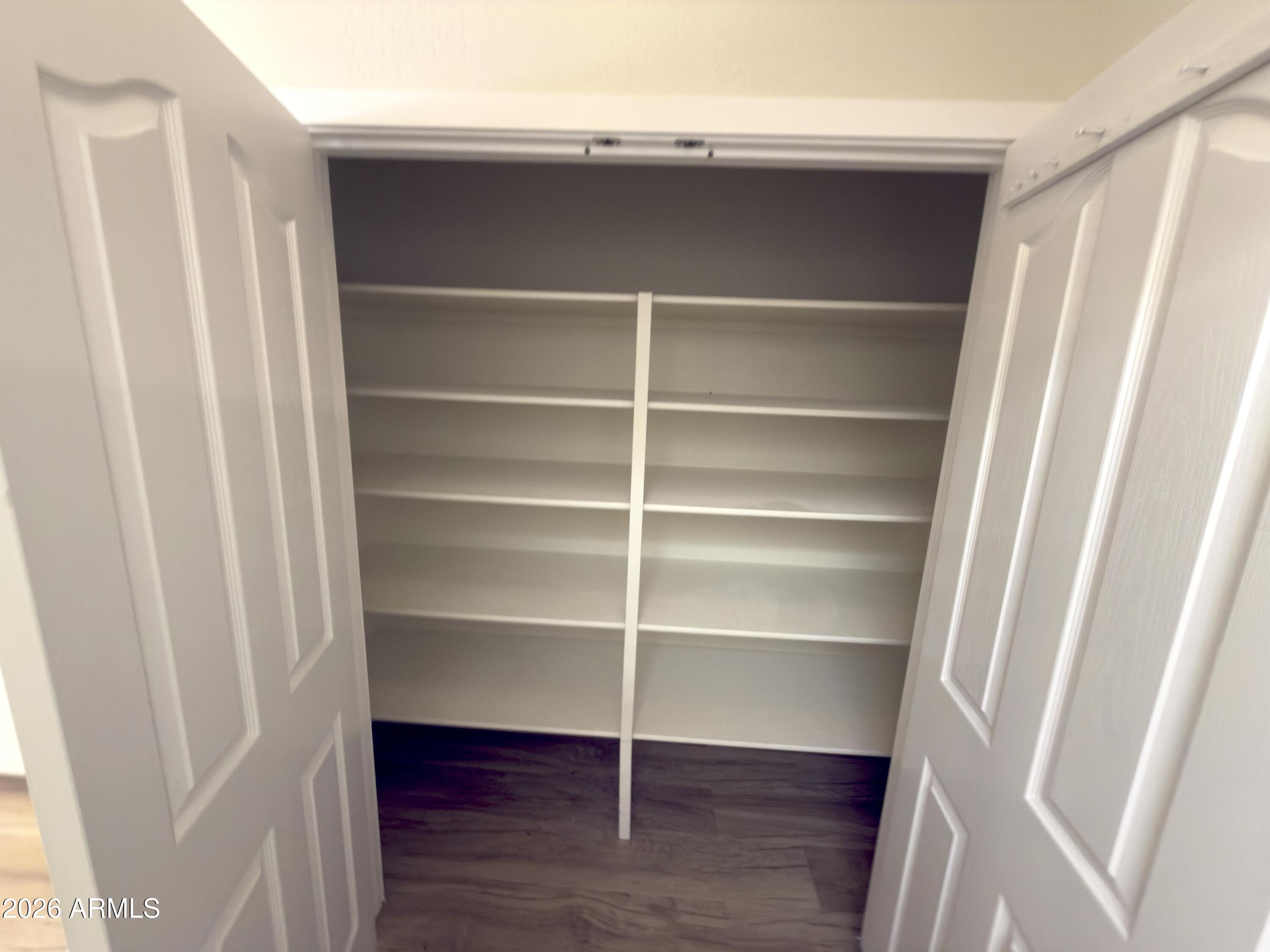 5319 West Coles Road Laveen, AZ 85339 - Photo 11 of 20 a view of walk in closet with empty racks