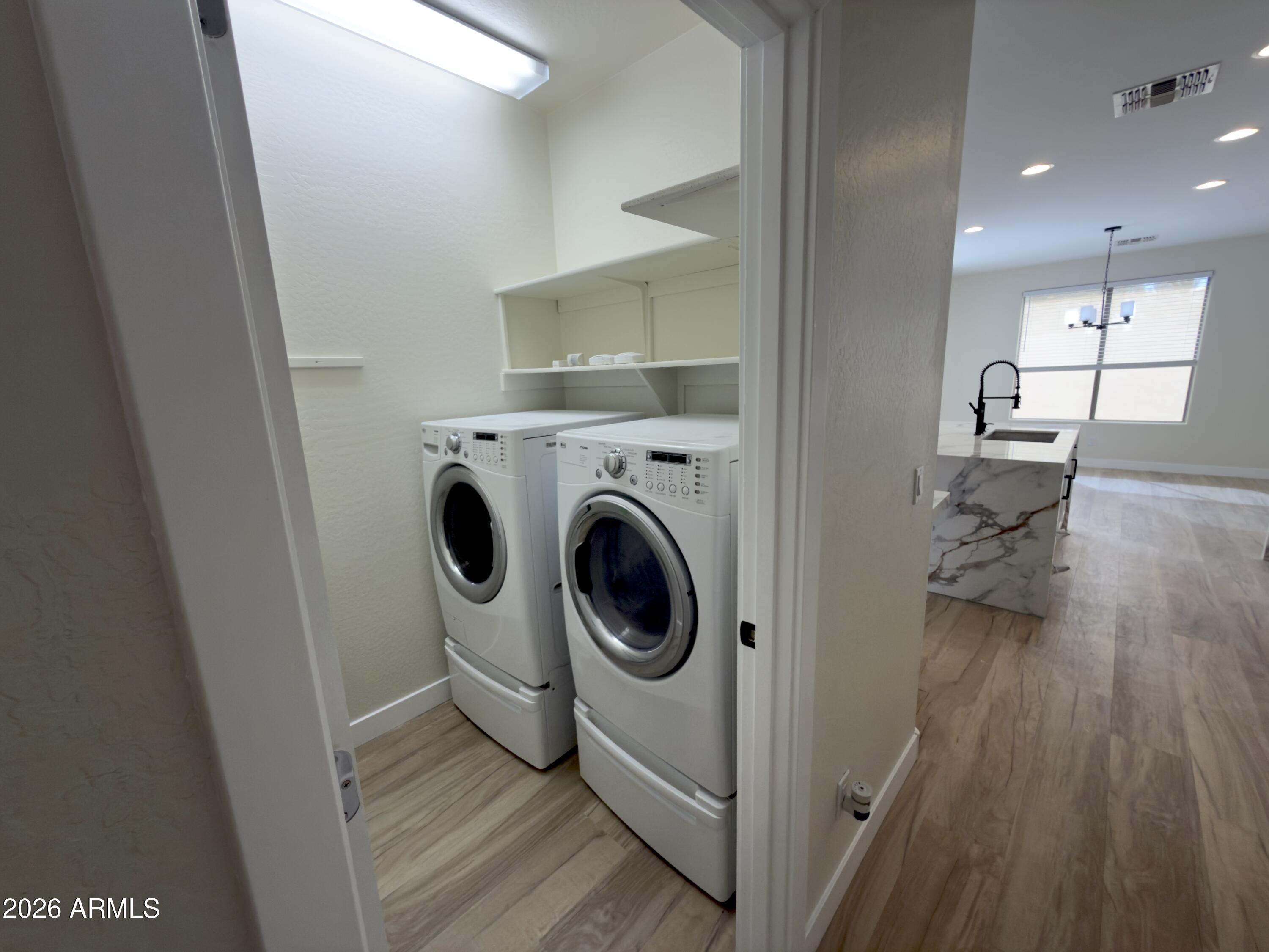 5319 West Coles Road Laveen, AZ 85339 - Photo 12 of 20 a view of a hallway with washer and dryer