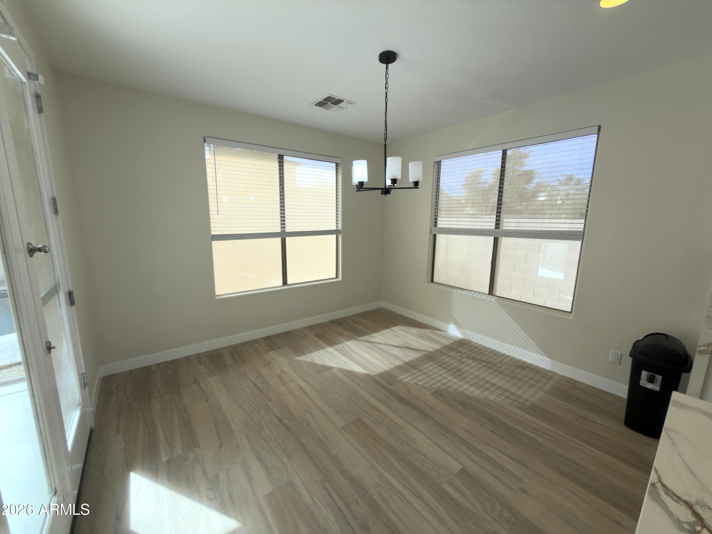 5319 West Coles Road Laveen, AZ 85339 - Photo 15 of 20 a view of empty room with wooden floor and fan