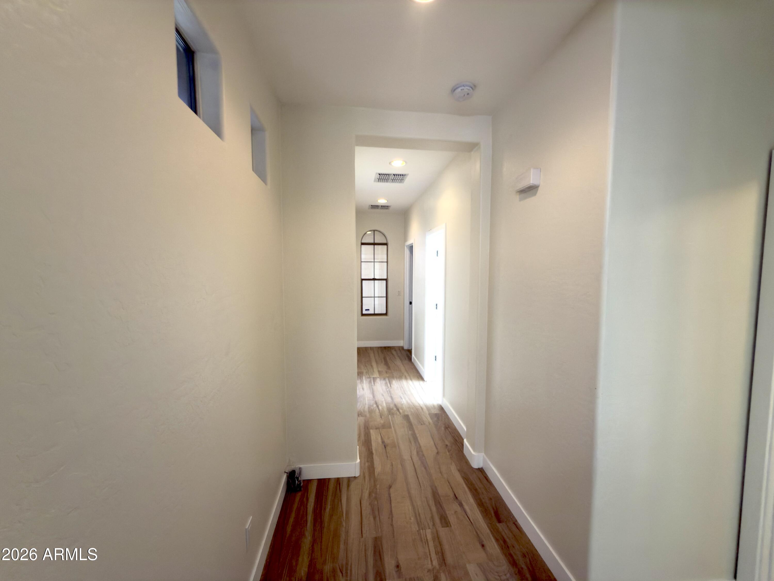 5319 West Coles Road Laveen, AZ 85339 - Photo 20 of 20 a view of a hallway with wooden floor