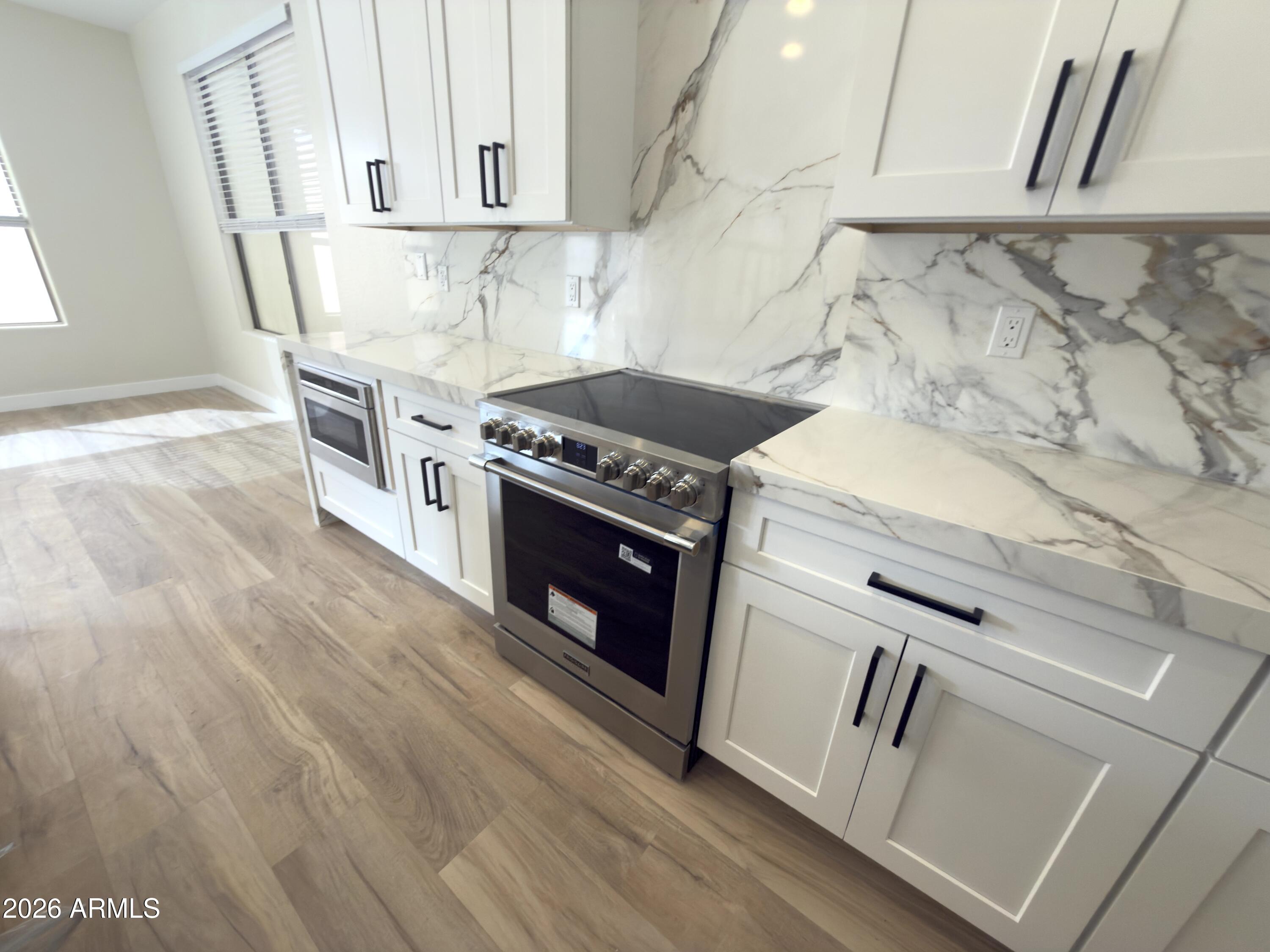 5319 West Coles Road Laveen, AZ 85339 - Photo 2 of 20 a kitchen with a stove top oven and cabinets