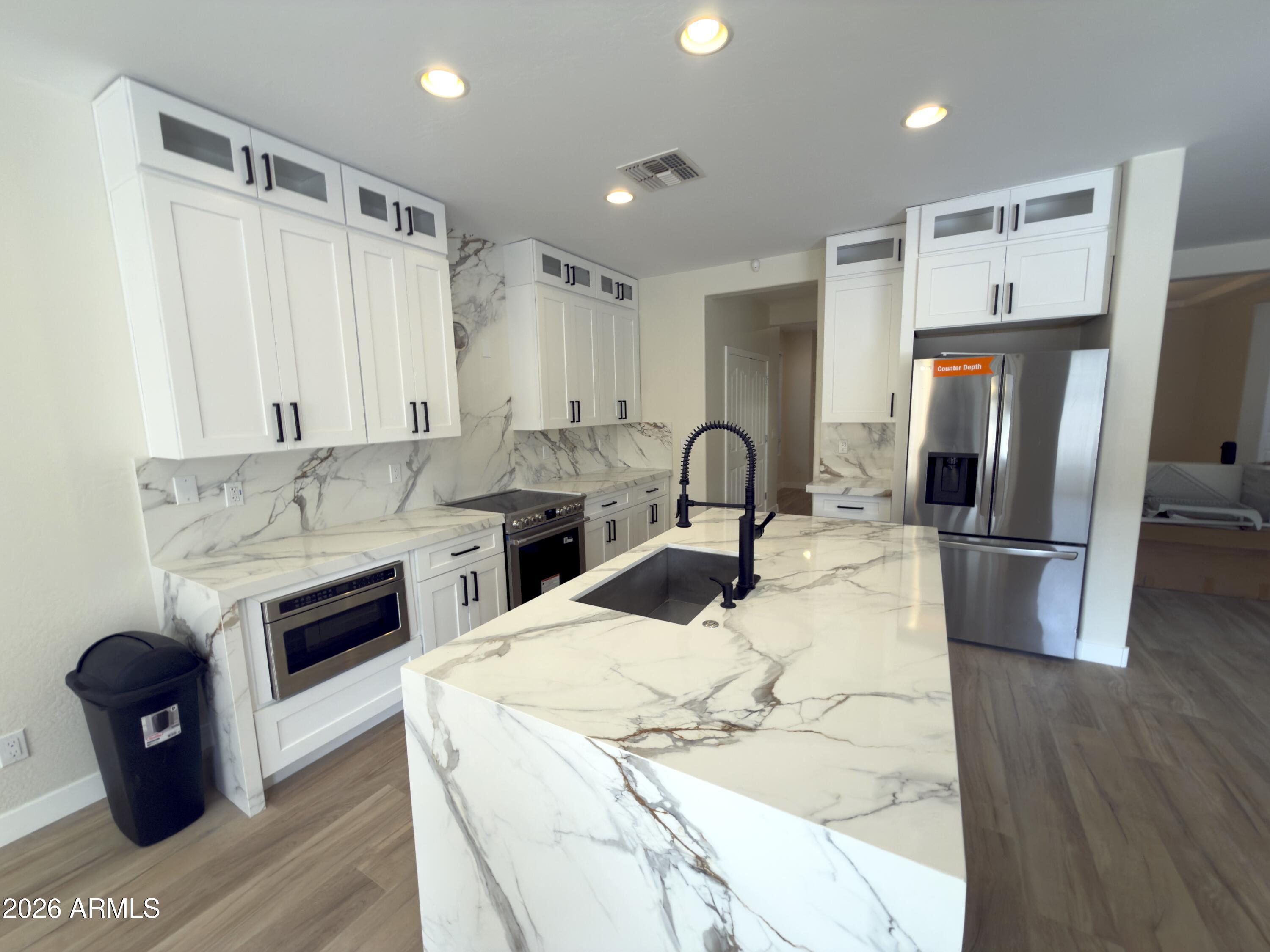 5319 West Coles Road Laveen, AZ 85339 - Photo 4 of 20 a kitchen with stainless steel appliances granite countertop a refrigerator a stove and a sink