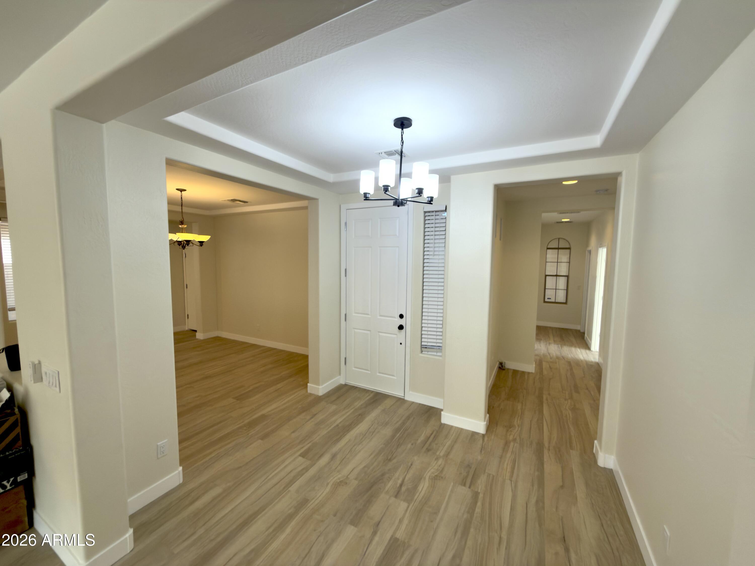 5319 West Coles Road Laveen, AZ 85339 - Photo 8 of 20 a view of a hallway with wooden floor and a bathroom