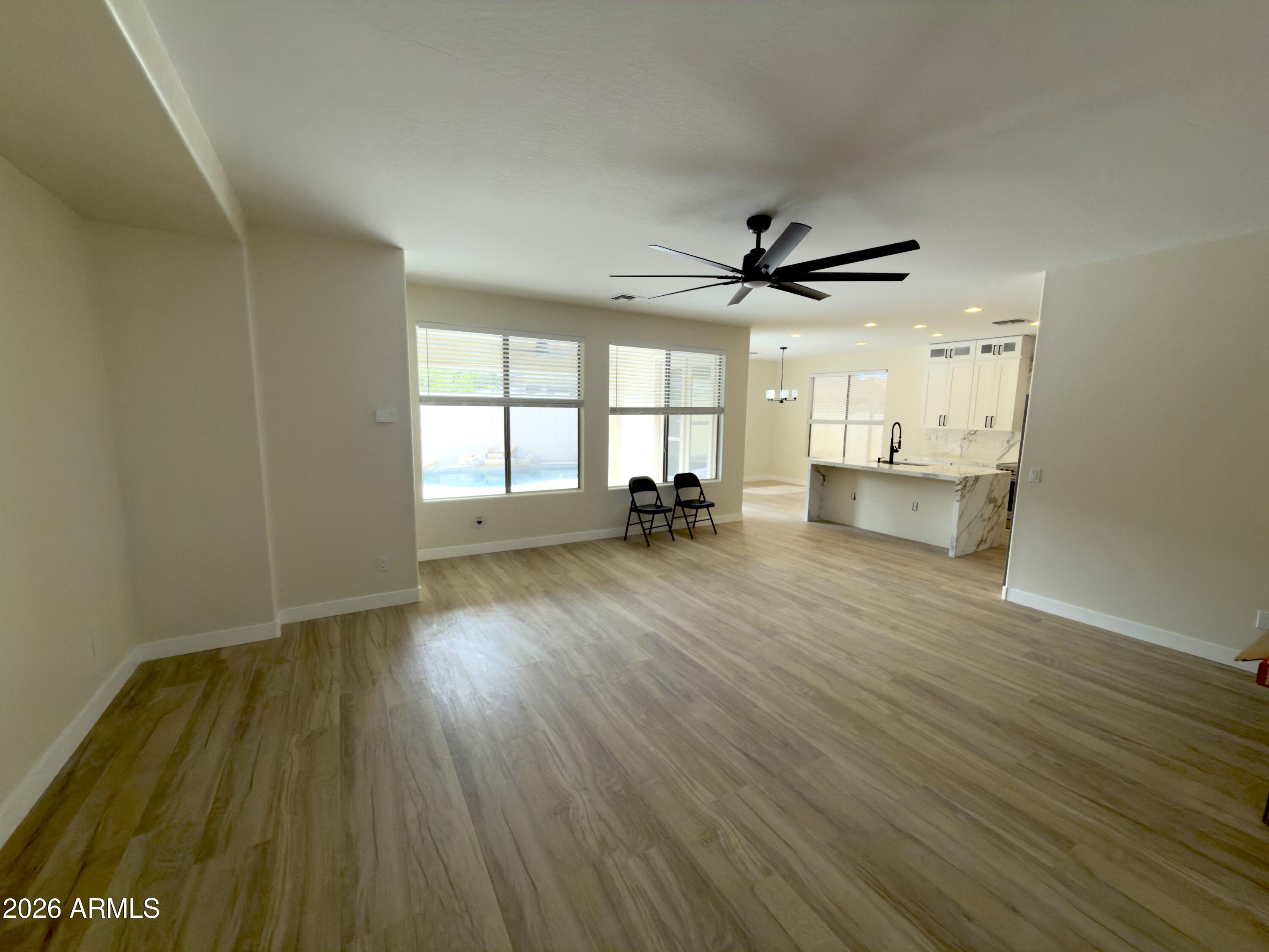5319 West Coles Road Laveen, AZ 85339 - Photo 9 of 20 wooden floor in an empty room with a window