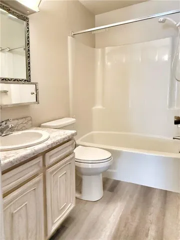 a view of a street with cars parked on the roadside