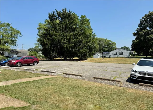 a view of yard with swimming pool and trees