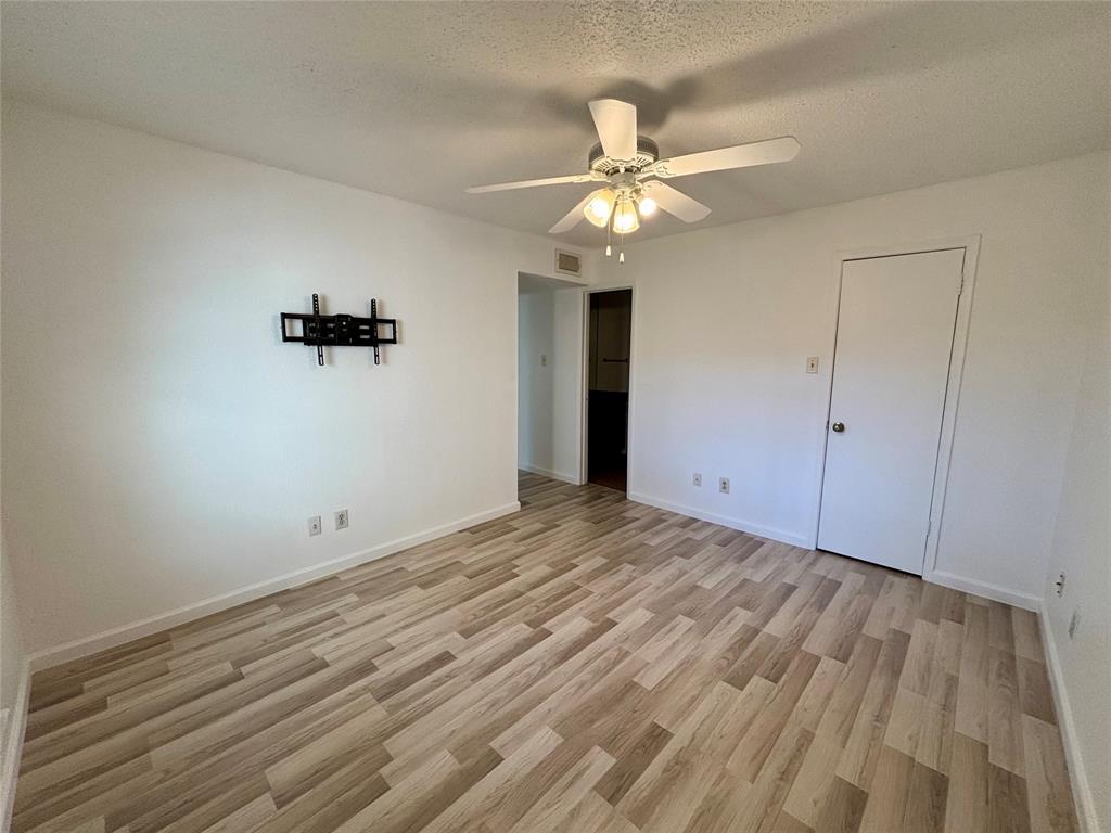 12480 Abrams Road, Unit 2805 Dallas, TX 75243 - Photo 9 of 18 Unfurnished bedroom with a textured ceiling, light wood-type flooring, and a ceiling fan