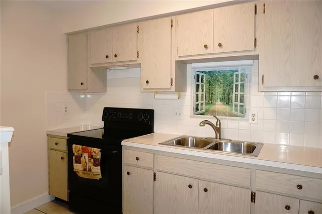 a kitchen with stainless steel appliances a sink stove and cabinets