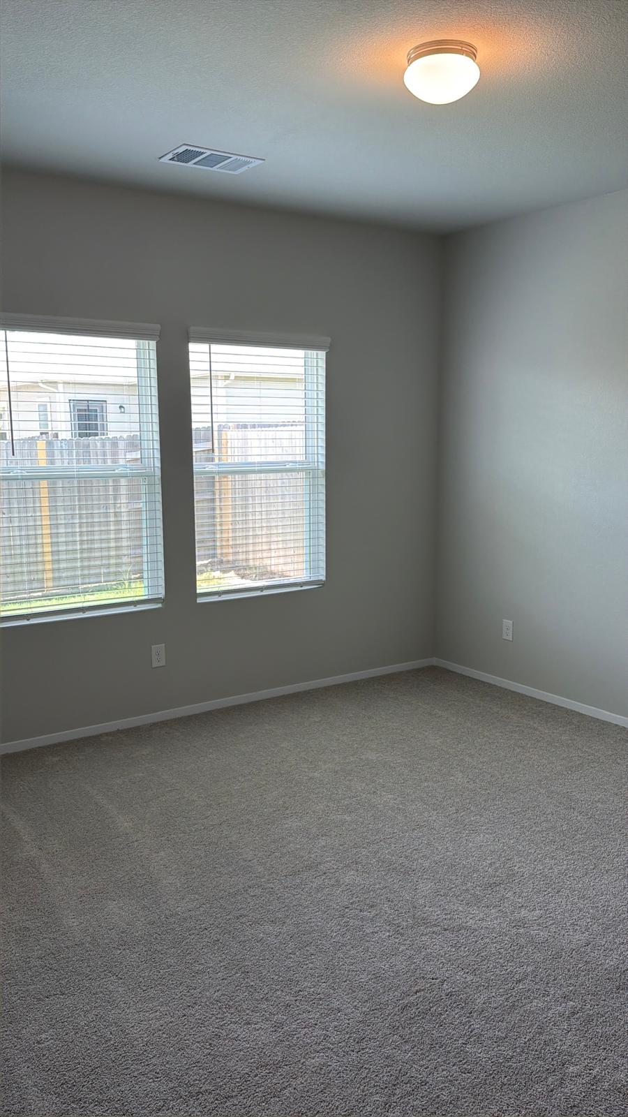 2701 Towy Road Manor, TX 78653 - Photo 22 of 35 Comfortable carpeted flooring creates a cozy ambiance in this well-lit room.