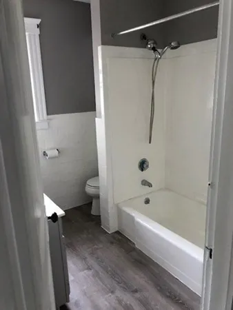 a bathroom with a bathtub and a toilet