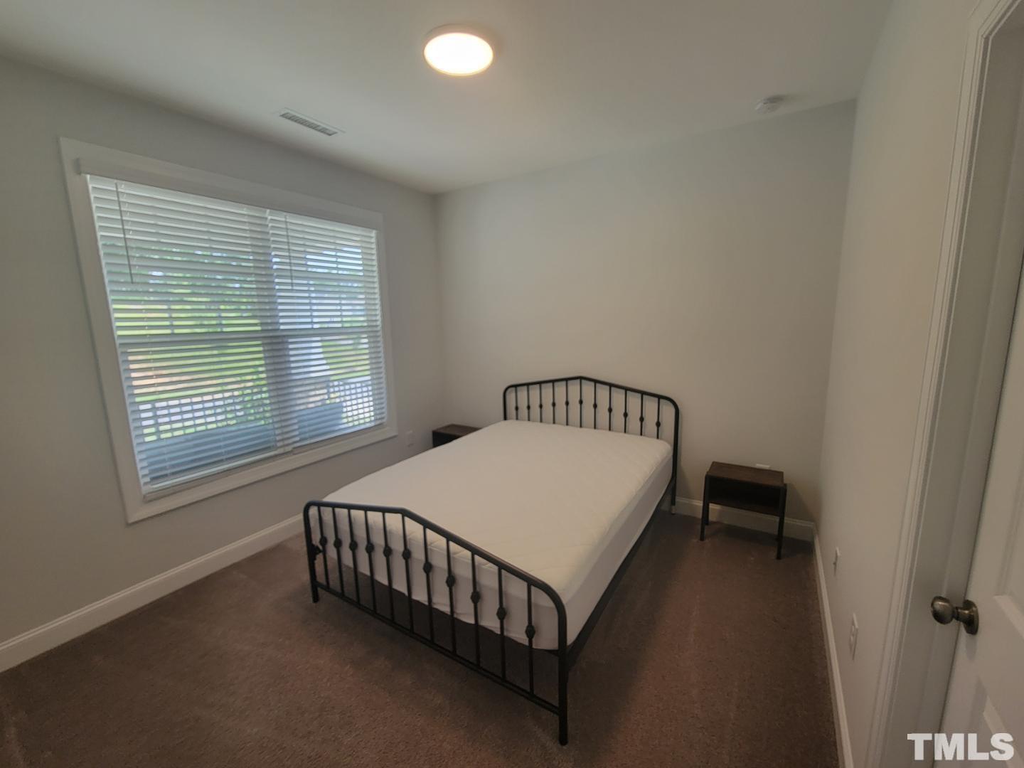 105 Winding Creek Loop Chapel Hill, NC 27517 - Photo 12 of 47 a bed sitting in a bedroom next to a window