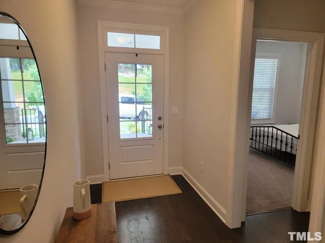 a view of a room with wooden floor and windows