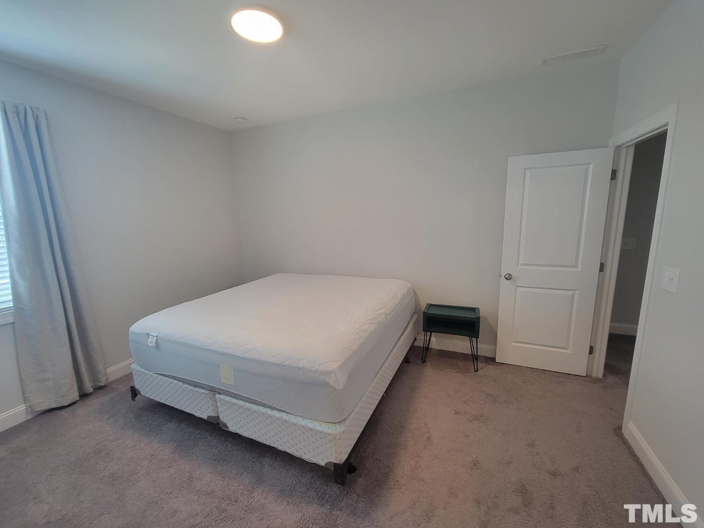 105 Winding Creek Loop Chapel Hill, NC 27517 - Photo 14 of 47 a bed sitting in a room next to a window