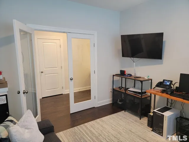 a view of a livingroom with furniture and a flat screen tv