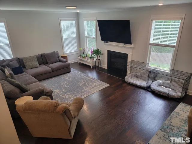 a living room with furniture fireplace and flat screen tv