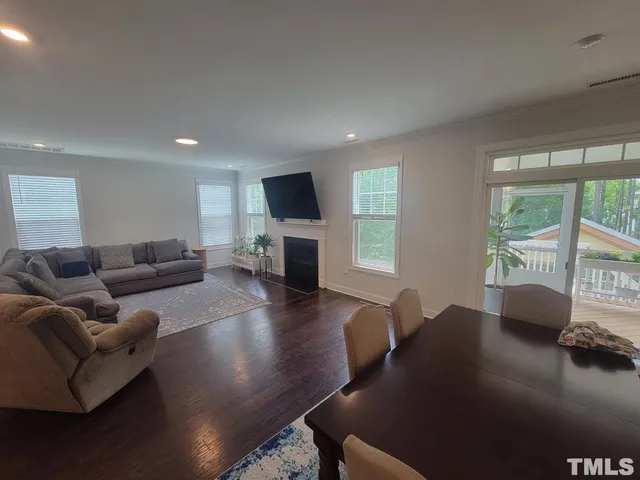 a living room with furniture window and a flat screen tv